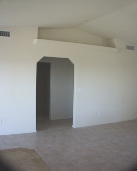 Dining room - living room / archway - right goes to garage, straight goes into laundry room, left goes into master bedroom / pot shelf above arch on both sides of living room